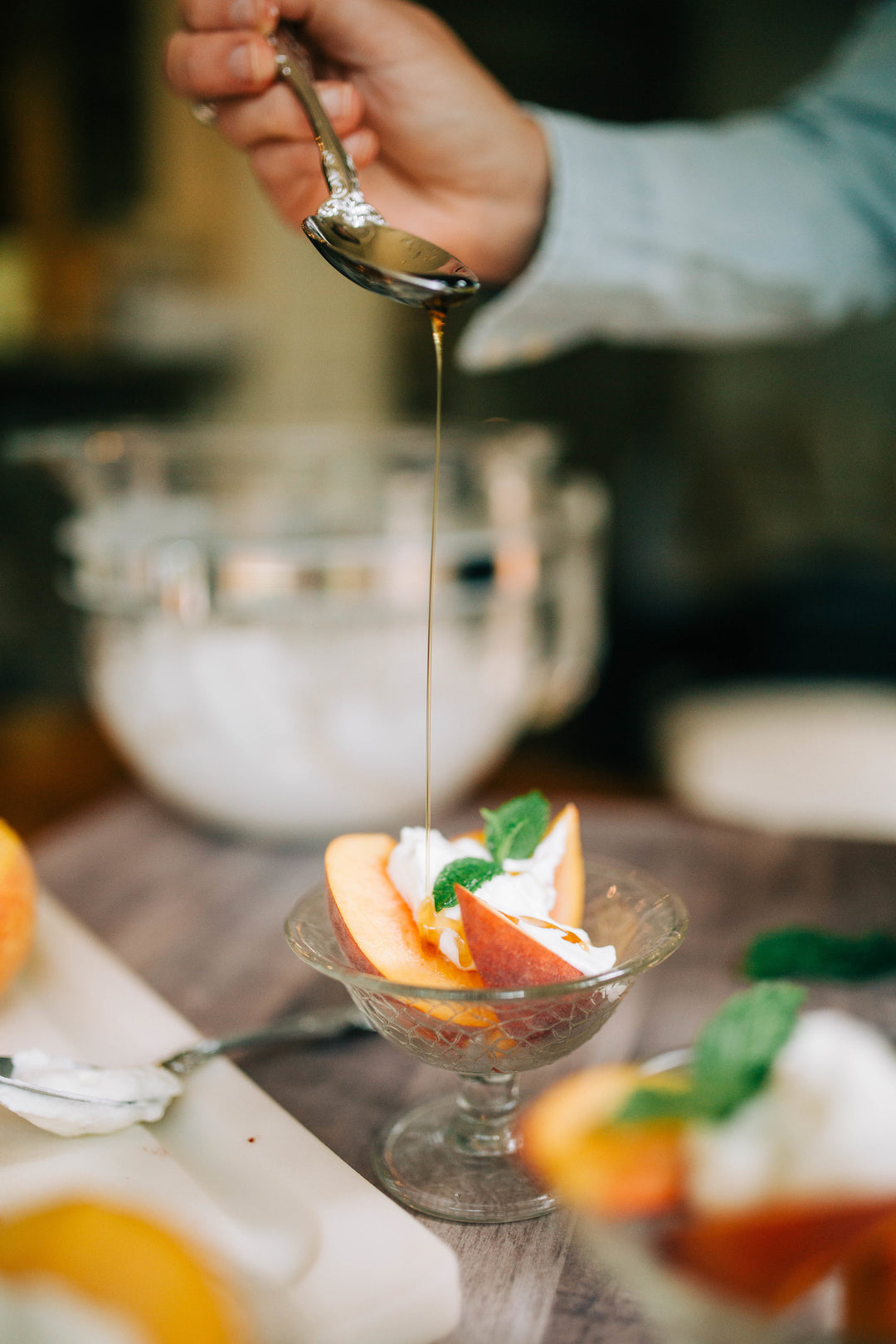 Bourbon Whipped Cream topping a bowl of peaches